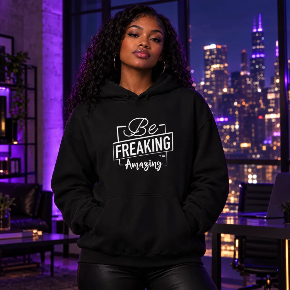 Woman in a city loft at night wearing the black Be Freaking Amazing hoodie