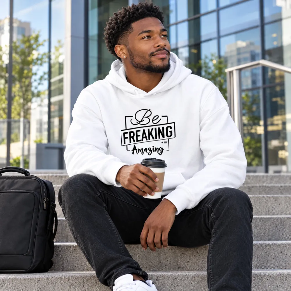 Man on office steps with coffee wearing the white Be Freaking Amazing hoodie